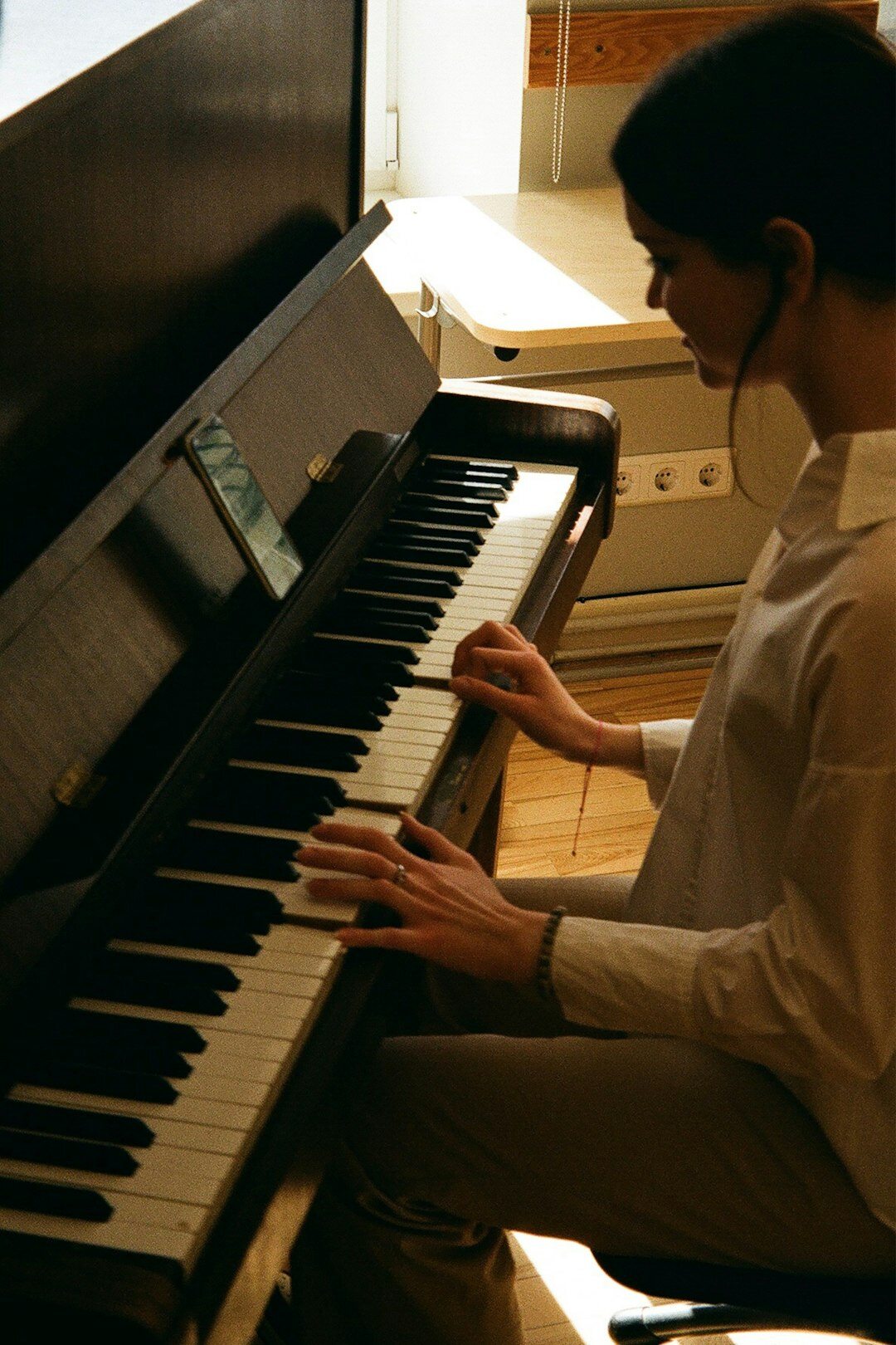 female tv host at piano
