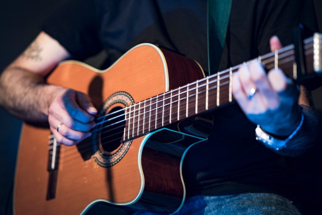 musician playing guitar on stage